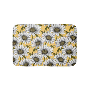 White daisies, wild flowers on yellow bath mat