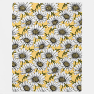 White daisies, wild flowers on yellow fleece blanket