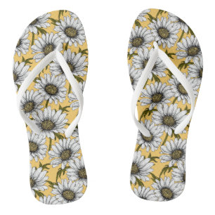 White daisies, wild flowers on yellow flip flops