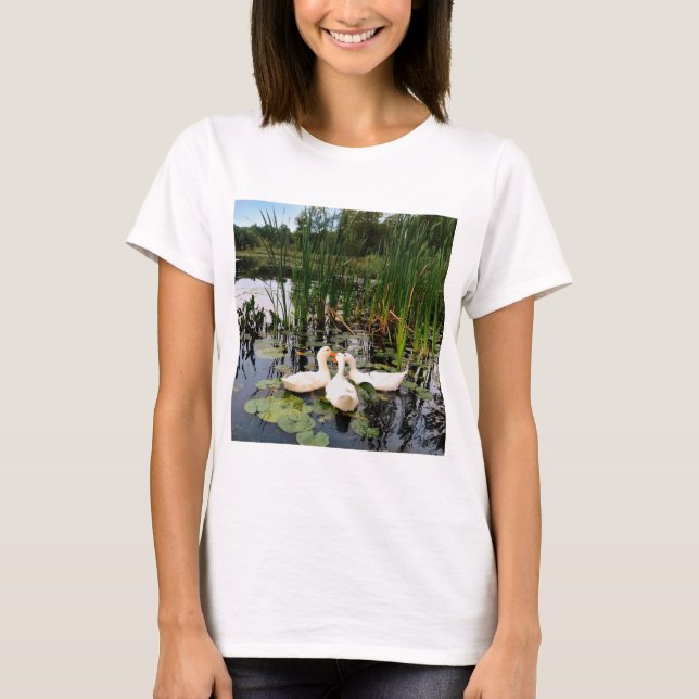 White ducks, lily pads, cattails, lake shore T-Shirt (Front)