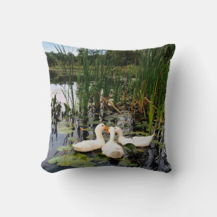 White ducks, lily pads, cattails, lake shore throw pillow