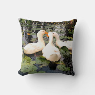 White ducks, lily pads, cattails, lake shore throw pillow