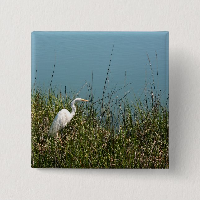 White egret standing in grass w water 2 inch square button (Front)