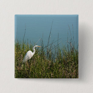 White egret standing in grass w water 2 inch square button