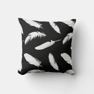 White feather print on black throw pillow