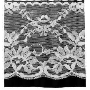 White floral lace on a black background.