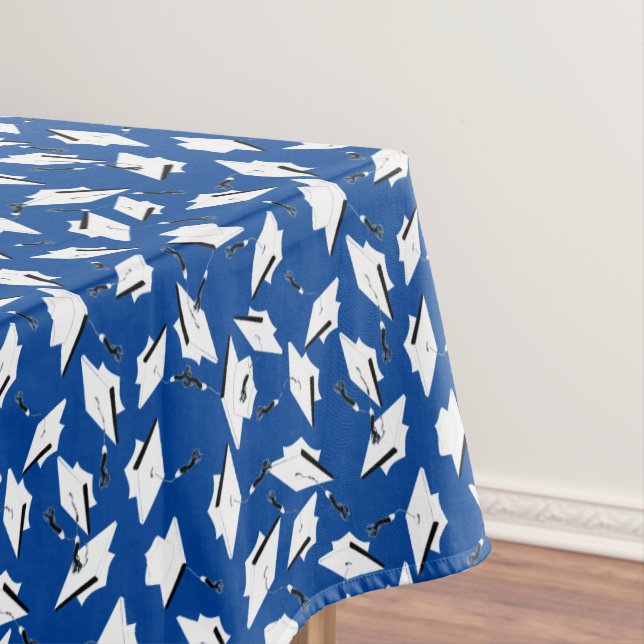 White Graduation Caps Tossed in the Air on Blue Tablecloth (In Situ)