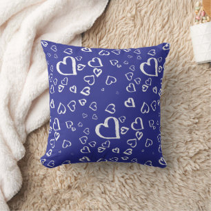 White hearts on blue throw pillow