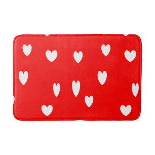 White hearts on red bath mat