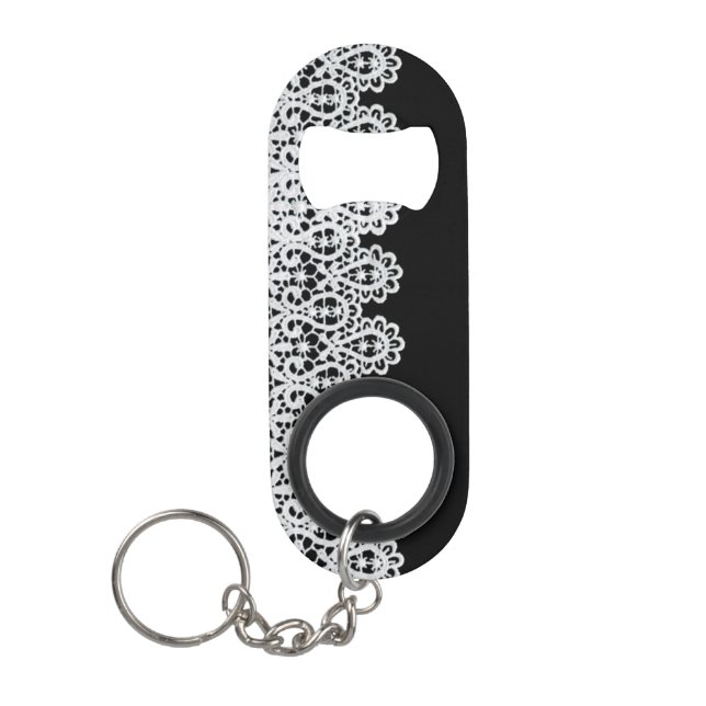 White lace forms a delicate border against black keychain bottle opener (Front)