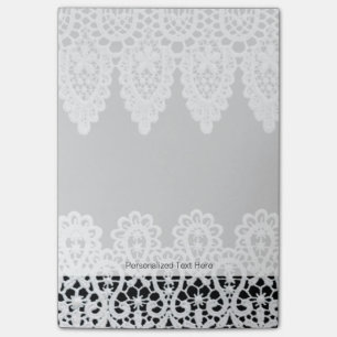 White lace forms a delicate border against black post-it notes