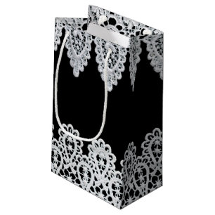 White lace forms a delicate border against black small gift bag