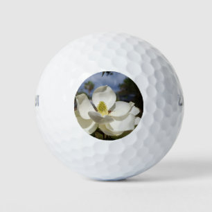 White Magnolia flower and a bee on golf ball