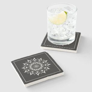 White mandala on black stone coaster