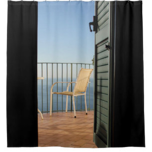 White metal armchair beside fence in the morning