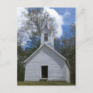 white old church in the mountains postcard