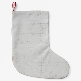 White painted concrete wall concrete small christmas stocking