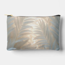 White palm leaves in golden-pastel tones