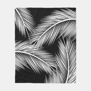 White palm leaves on black colour background fleece blanket