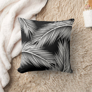 White palm leaves on black colour background throw pillow