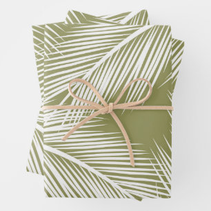 White palm leaves on green colour background wrapping paper sheet