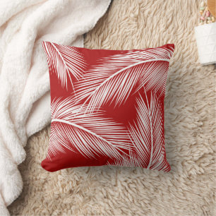 White palm leaves on red colour background throw pillow