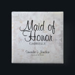 White Peonies & Hearts Wedding Maid of Honour Name 2 Inch Square Button<br><div class="desc">This beautiful name tag button is perfect for identifying key members of the wedding party at the bridal shower, rehearsal dinner, or wedding reception. It features modern black script lettering over a background of reflecting white peony flowers and hearts. The text is fully customizable and reads: Maid of Honour, with...</div>