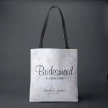 White Peony Flowers & Hearts Bridesmaid Wedding Tote Bag<br><div class="desc">This beautiful tote bag is perfect for thanking your bridesmaids. It features modern black script lettering over a background of reflecting white peony flowers and hearts. The text is fully customizable and reads: Bridesmaid, with a place for her name, the couple's names and wedding date. Perfect for filling with wedding...</div>