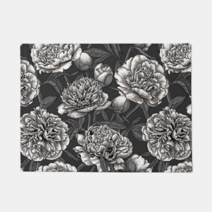White peony flowers on dark grey doormat