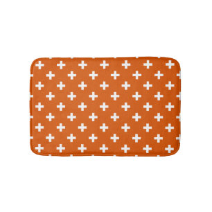 White polka crosses on burnt orange bath mat