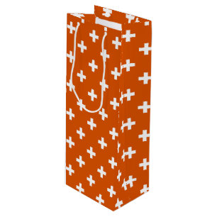 White polka crosses on burnt orange wine gift bag