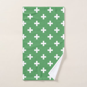 White polka crosses on green hand towel