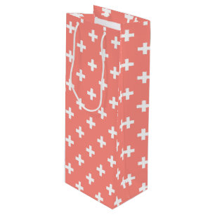 White polka crosses on peach wine gift bag