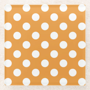White polka dots on amber glass coaster