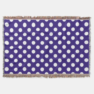White polka dots on dark blue throw blanket