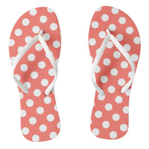 White polka dots on living coral flip flops