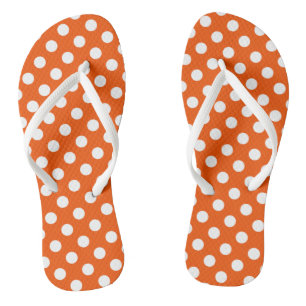 White polka dots on orange flip flops