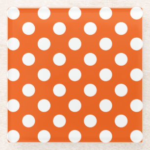 White polka dots on orange glass coaster