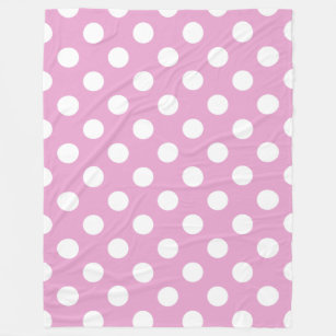 White polka dots on pale pink fleece blanket