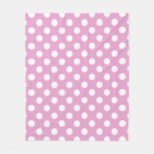 White polka dots on pale pink fleece blanket