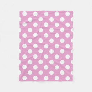 White polka dots on pale pink fleece blanket