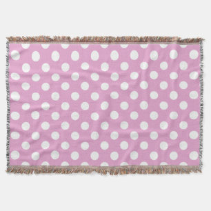 White polka dots on pale pink throw blanket