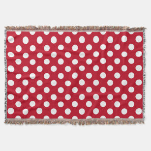 White polka dots on red throw blanket