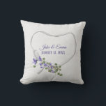 White Ribbon Heart with Wedding Date Throw Pillow<br><div class="desc">Purple flowers with green ivy bouquet on white satin ribbon heart on off white speckled background.
Names and wedding date are editable.
Can be used for anniversary or wedding gift.</div>