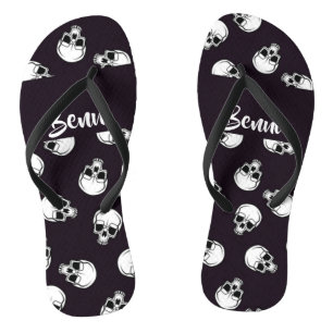 White skulls on purple pattern flip flops