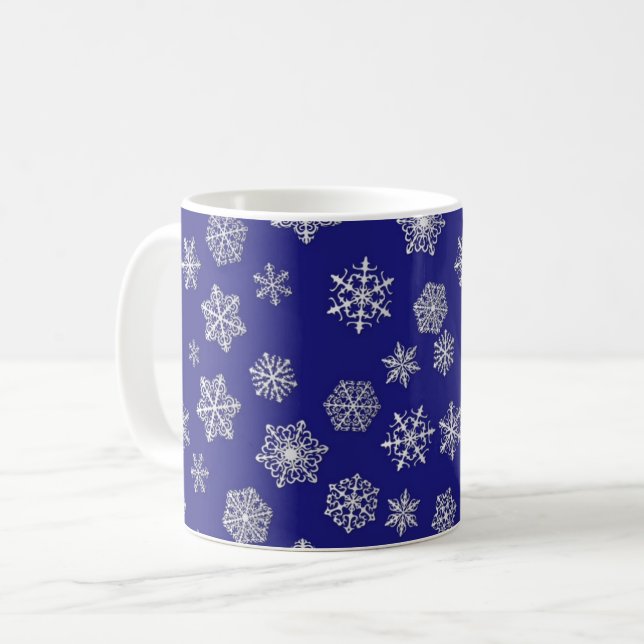 White snowflakes against deep cobalt blue coffee mug (Front Left)