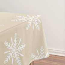 White snowflakes on beige Xmas tablecloth.