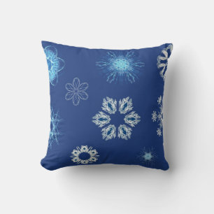 White snowflakes on blue throw pillow