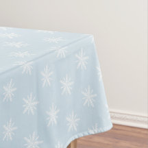 White snowflakes on blue Xmas tablecloth.