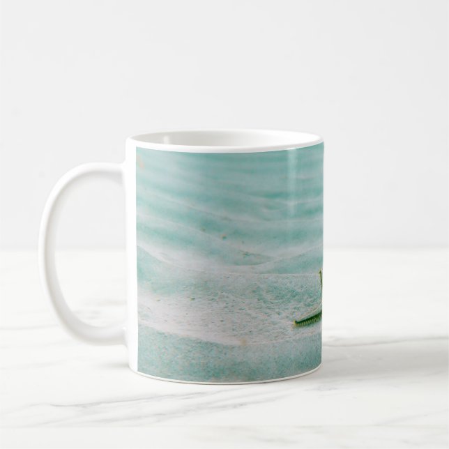 White starfish on sand underwater in the morning coffee mug (Left)